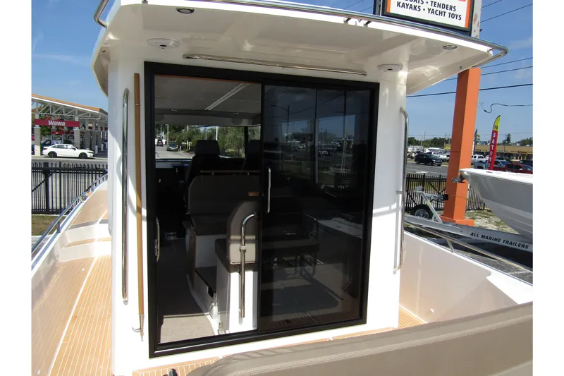  Yacht Photos Pics 2025 Nimbus Commuter 11 boat interior view with sliding glass door.