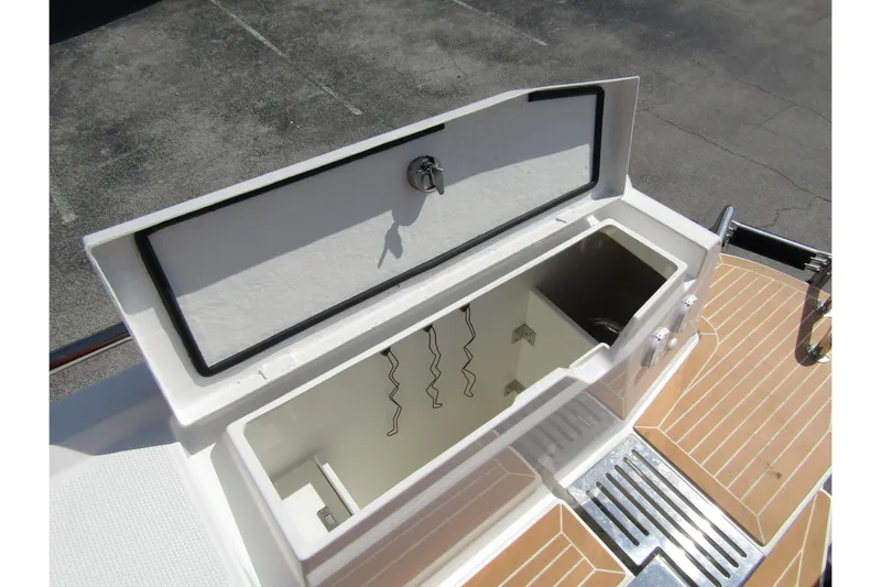  Yacht Photos Pics Storage compartment on 2025 Nimbus Commuter 11 boat with open lid and lock.