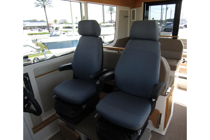  Yacht Photos Pics Interior of 2025 Nimbus Commuter 11 with two comfortable captain chairs.