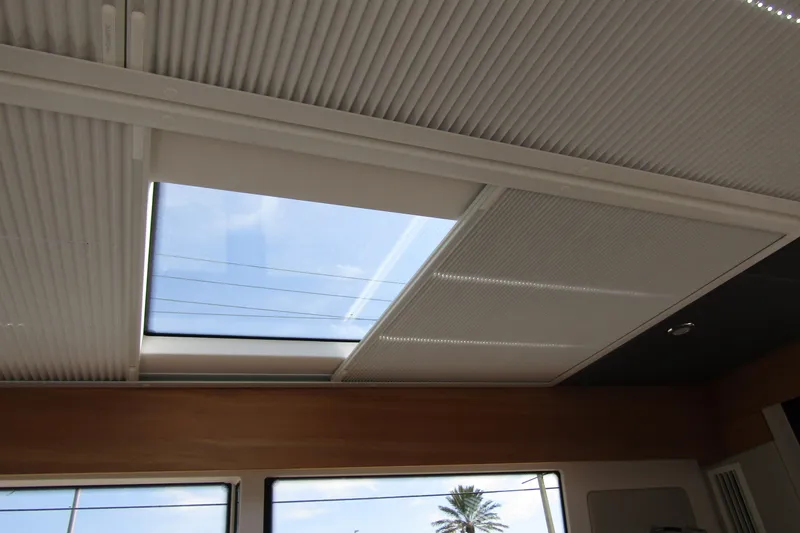  Yacht Photos Pics 2025 Nimbus Commuter 11 interior skylight with retractable blinds, showcasing modern design.