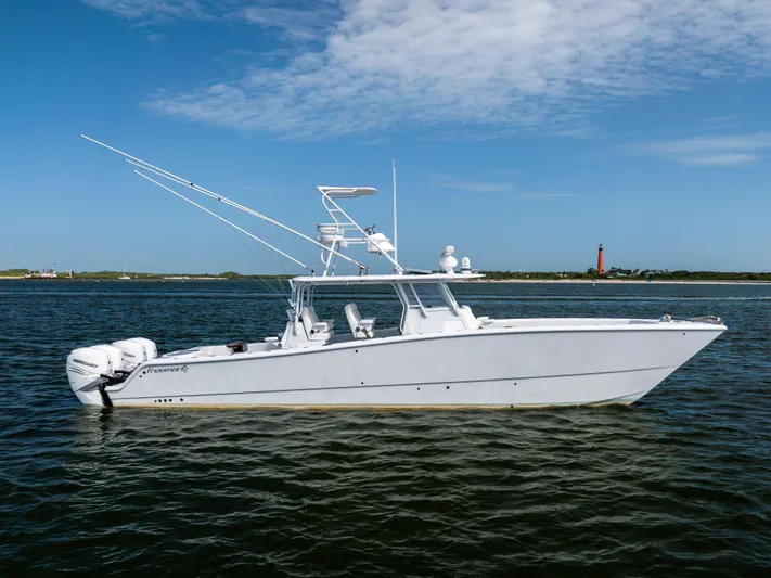  Yacht Photos Pics 2023 Freeman 42 LR boat on calm water with clear blue sky background.