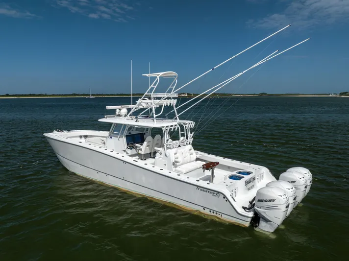  Yacht Photos Pics 2023 Freeman 42 LR boat with multiple outboard engines on calm water.