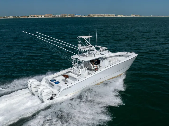  Yacht Photos Pics 2023 Freeman 42 LR boat cruising on open water with cityscape in background.
