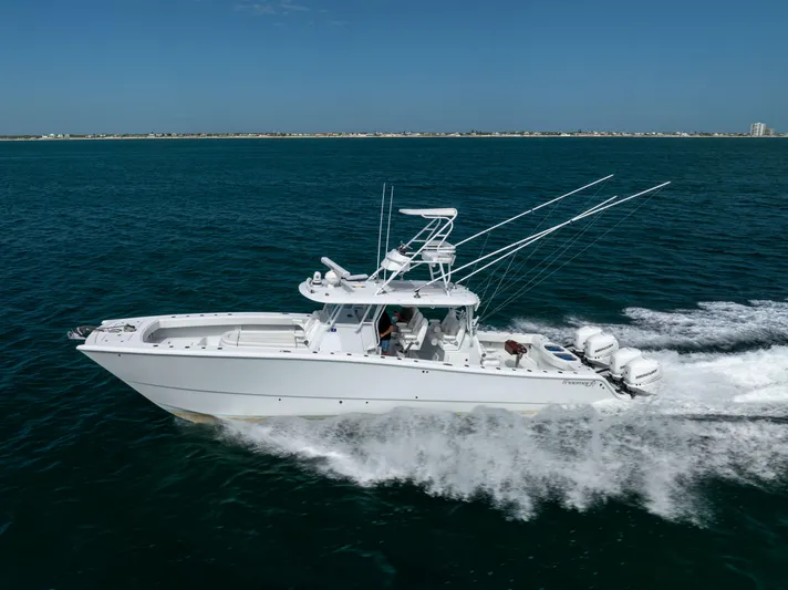  Yacht Photos Pics 2023 Freeman 42 LR boat cruising on open water, showcasing sleek design and powerful engines.