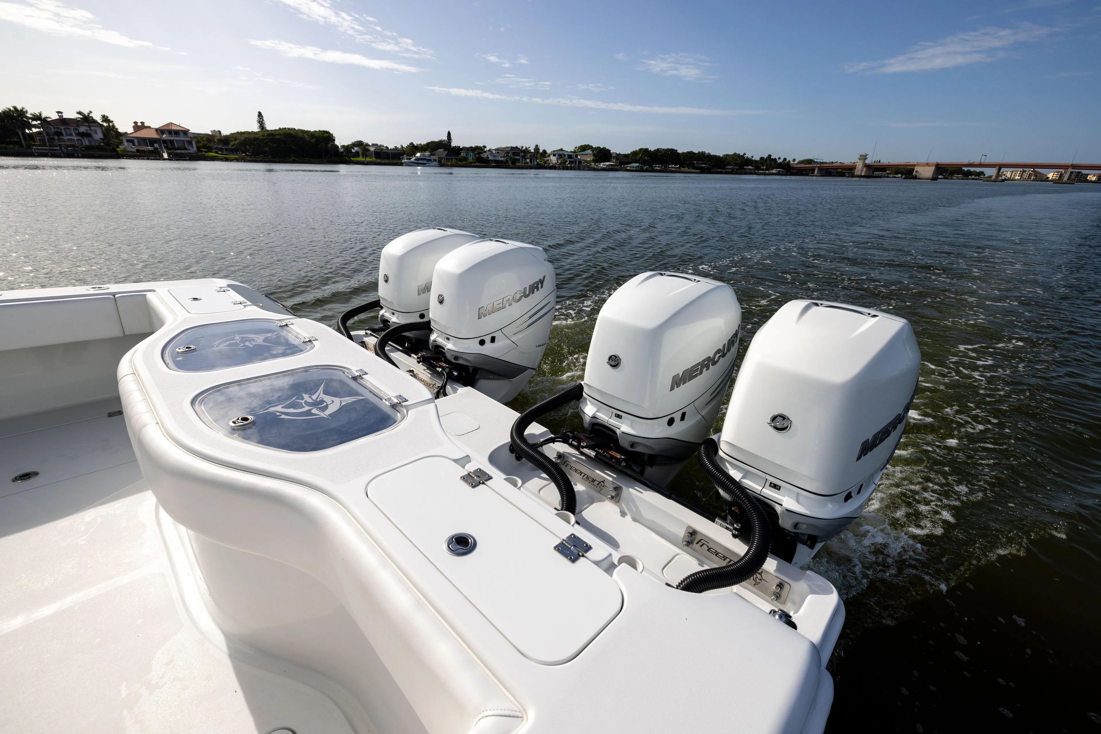  Yacht Photos Pics 2023 Freeman 42 LR boat with four Mercury outboard engines on a calm waterway.
