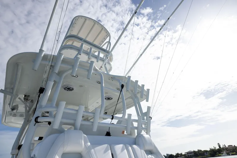  Yacht Photos Pics 2023 Freeman 42 LR boat tower against a cloudy sky, showcasing fishing rods and equipment.