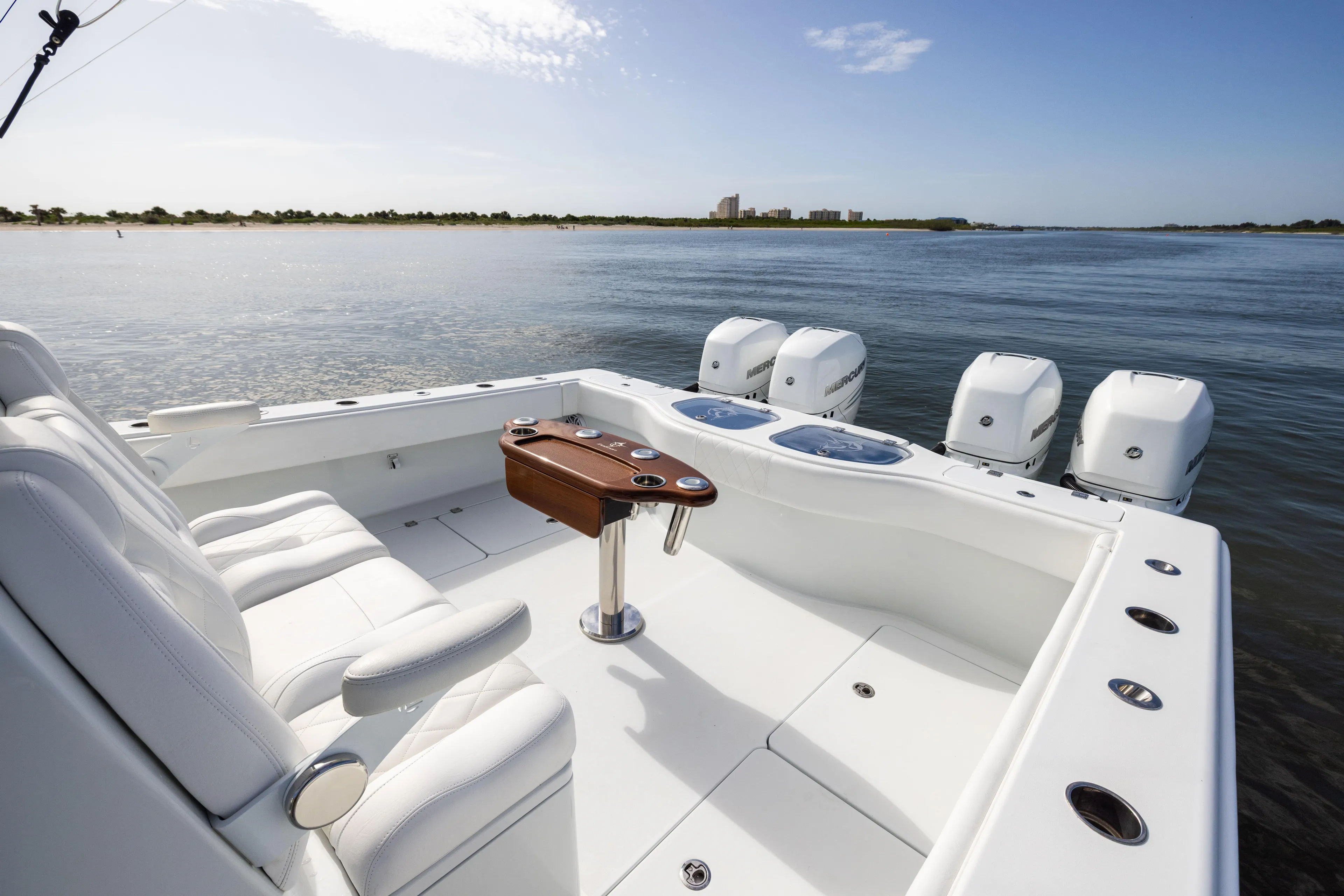  Yacht Photos Pics 2023 Freeman 42 LR boat with luxurious seating and powerful outboard engines on a calm waterway.