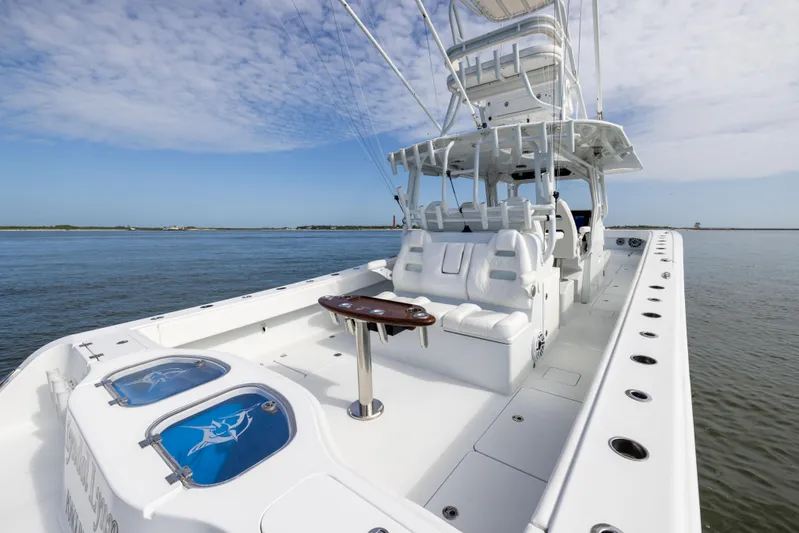  Yacht Photos Pics 2023 Freeman 42 LR boat on calm water, featuring spacious deck and seating.