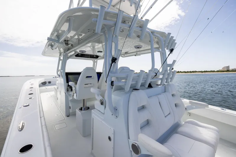  Yacht Photos Pics 2023 Freeman 42 LR boat interior with white seating and fishing rod holders.