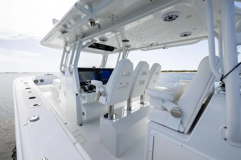  Yacht Photos Pics 2023 Freeman 42 LR boat interior with white seating and advanced navigation system.