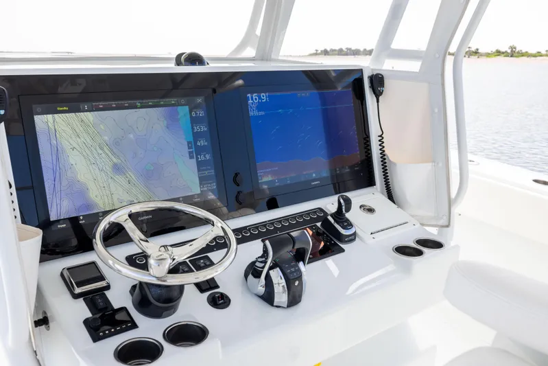  Yacht Photos Pics Control panel of 2023 Freeman 42 LR boat with navigation screens and steering wheel.