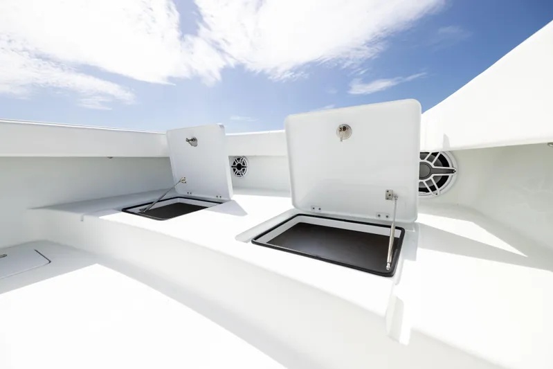  Yacht Photos Pics Open storage compartments on a 2023 Freeman 42 LR boat under a clear blue sky.