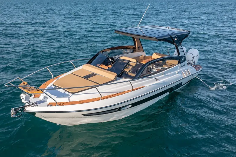  Yacht Photos Pics 2026 Hanover 305 boat cruising on open water, featuring sleek design and modern amenities.