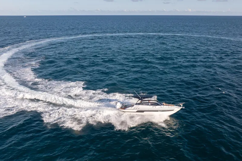  Yacht Photos Pics Aerial view of Hanover 305 yacht making a circular wake in the ocean, 2026 model.