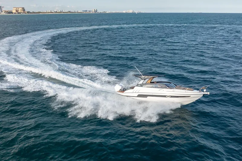 Yacht Photos Pics 2026 Hanover 305 speedboat cruising swiftly on open ocean waters.