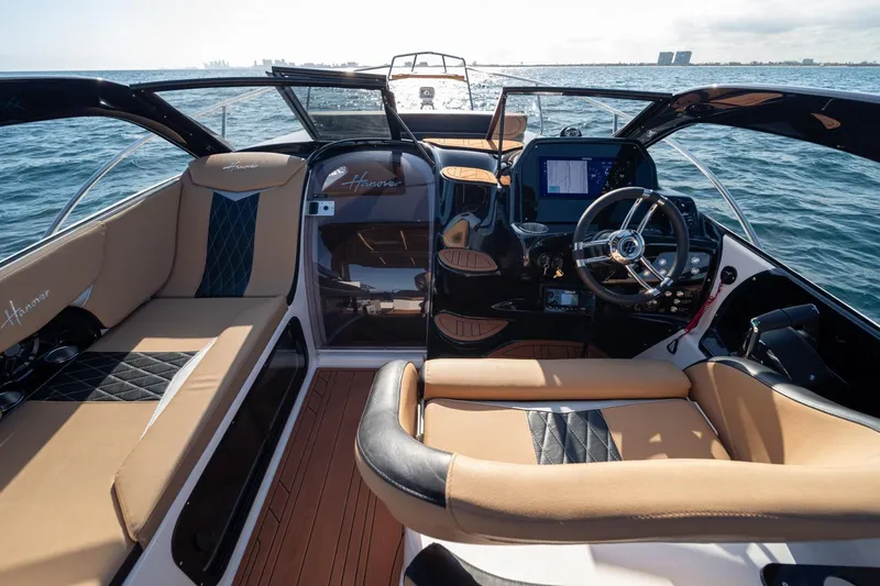  Yacht Photos Pics Luxurious 2026 Hanover 305 boat interior with plush seating and modern dashboard on open water.