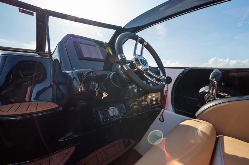  Yacht Photos Pics Interior view of 2026 Hanover 305 boat cockpit with steering wheel and controls.