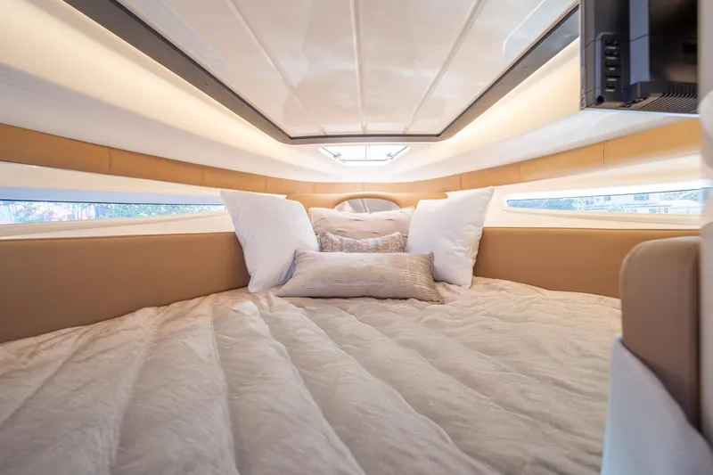  Yacht Photos Pics Luxurious cabin interior of 2026 Hanover 305 yacht with plush bedding and ambient lighting.