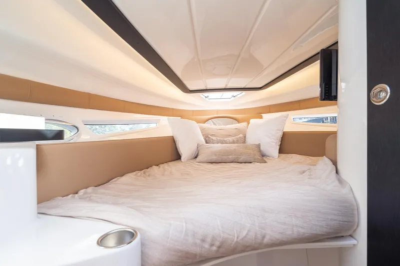  Yacht Photos Pics Luxurious interior cabin of 2026 Hanover 305 boat with cozy bedding.