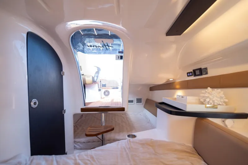  Yacht Photos Pics Interior of 2026 Hanover 305 boat cabin with modern design and cozy seating.