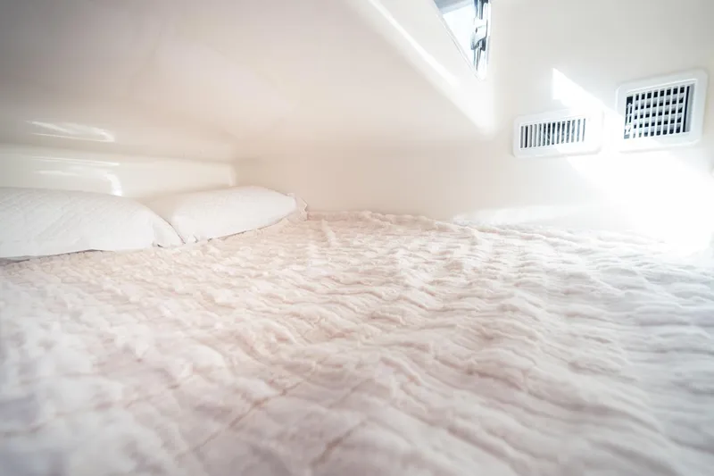  Yacht Photos Pics Interior of Hanover 305 (2026) RV with cozy bed and soft lighting.