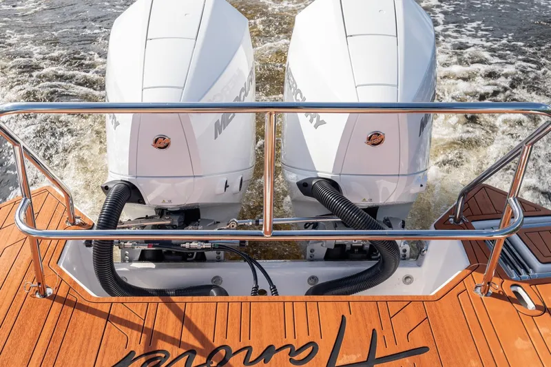  Yacht Photos Pics Twin Mercury outboard engines on a 2026 Hanover 305 boat, cruising through water.