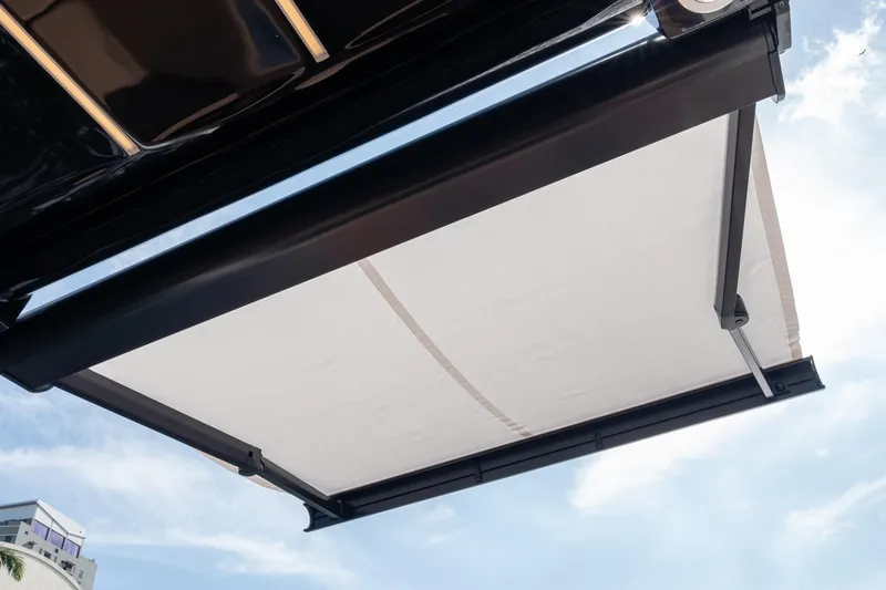  Yacht Photos Pics Modern Hanover 305 awning, 2026 model, extended under a clear blue sky.