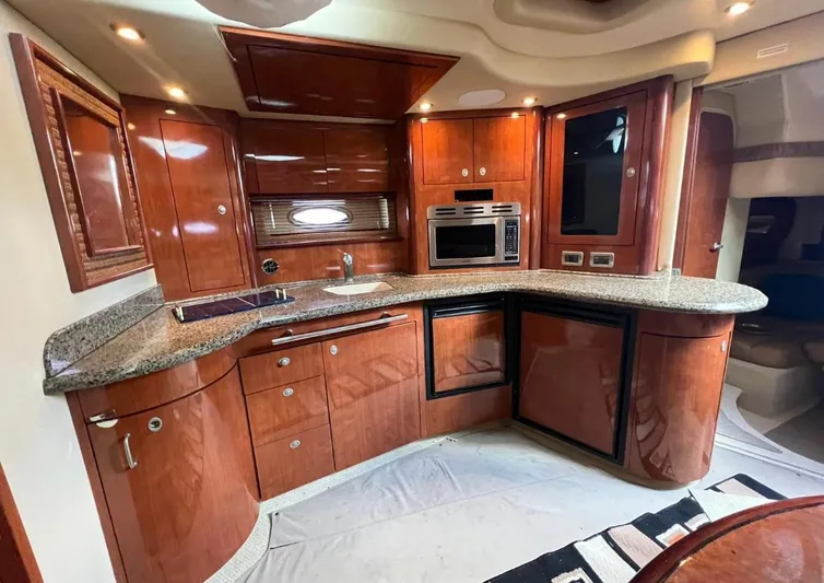  Yacht Photos Pics Luxurious 2004 Sea Ray 455 Sundancer yacht kitchen with modern appliances and wooden cabinetry.