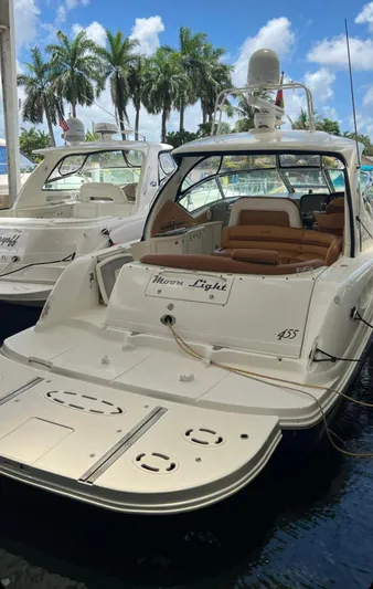  Yacht Photos Pics 2004 Sea Ray 455 Sundancer yacht docked with palm trees in the background.