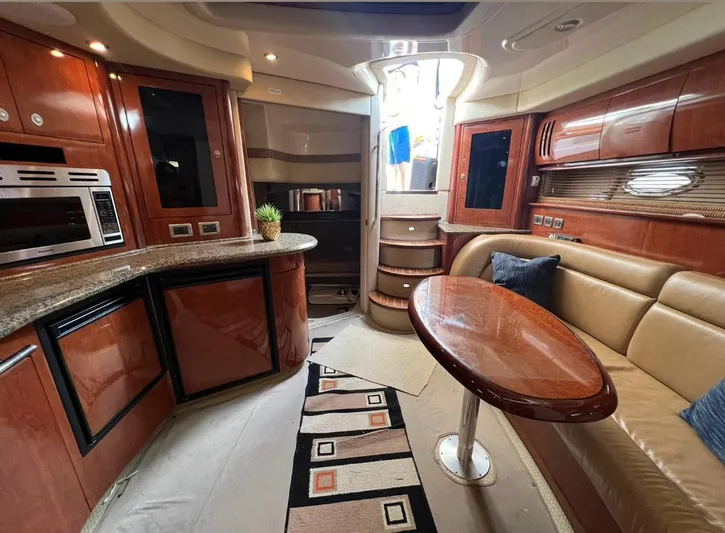  Yacht Photos Pics Luxurious interior of 2004 Sea Ray 455 Sundancer yacht with modern kitchen and seating area.