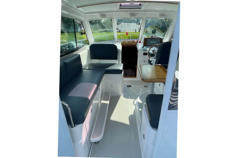 Old Fashioned (reserved) Yacht Photos Pics Interior of a 2011 Back Cove 29 boat with seating and helm station.