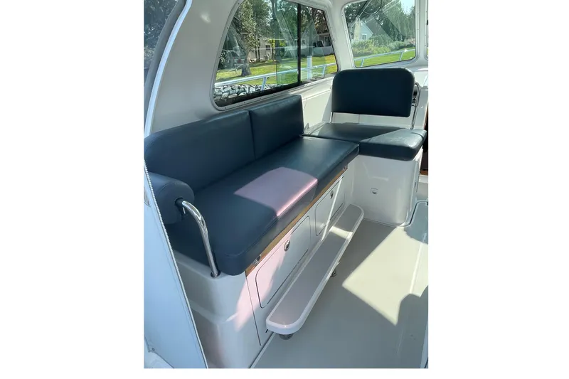 Old Fashioned (reserved) Yacht Photos Pics Interior seating of 2011 Back Cove 29 boat with blue cushions and storage.