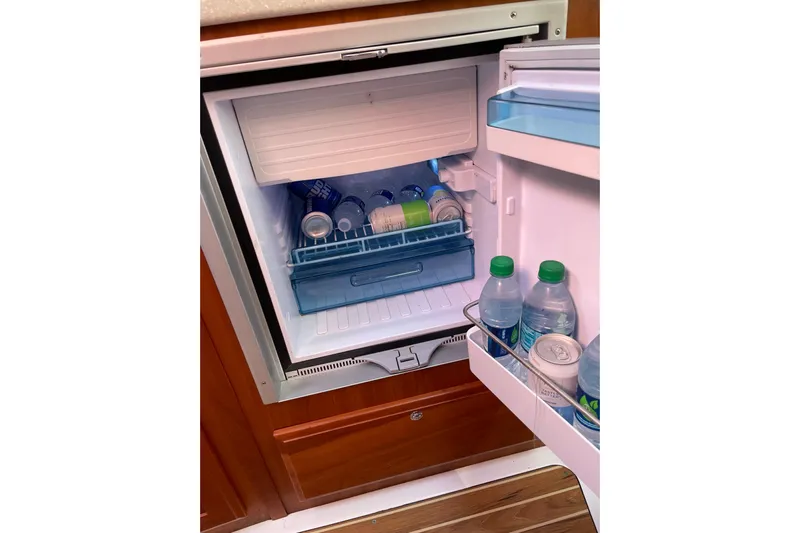 Old Fashioned (reserved) Yacht Photos Pics Mini fridge stocked with drinks inside a 2011 Back Cove 29 boat.