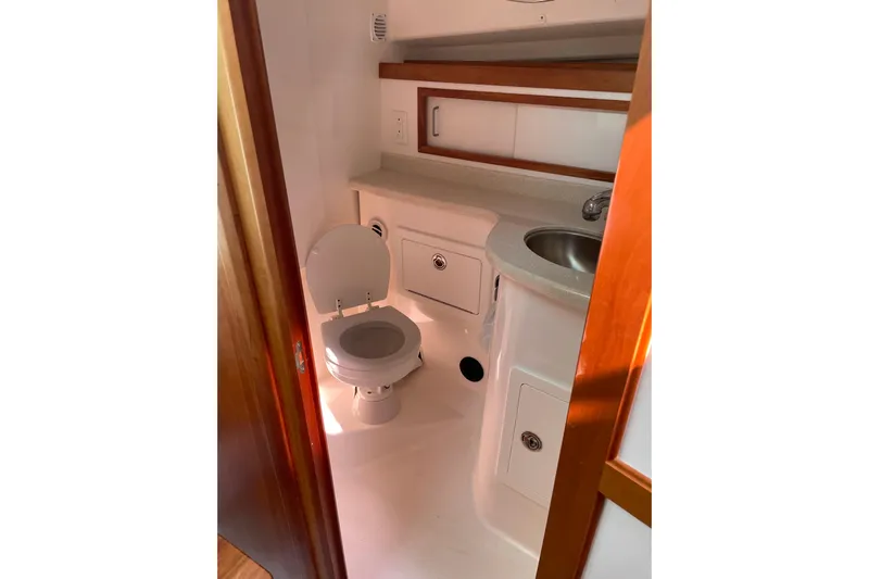 Old Fashioned (reserved) Yacht Photos Pics 2011 Back Cove 29 boat bathroom with toilet, sink, and storage cabinets.