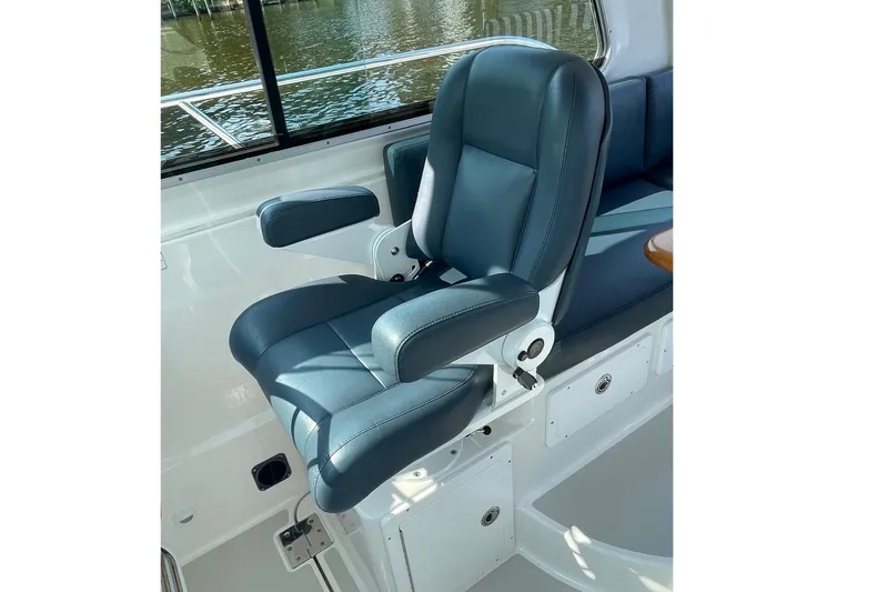 Old Fashioned (reserved) Yacht Photos Pics Luxurious seating on 2011 Back Cove 29 boat, featuring blue upholstery and armrests.