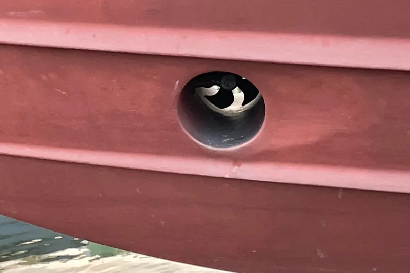 Old Fashioned (reserved) Yacht Photos Pics Close-up of a 2011 Back Cove 29 boat hull with a visible thruster.