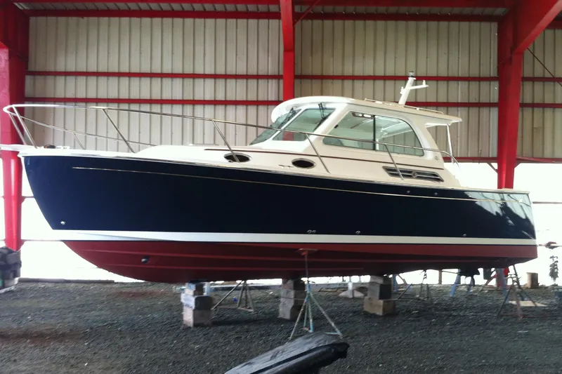 Old Fashioned (reserved) Yacht Photos Pics 2011 Back Cove 29 boat in storage, blue hull, red bottom, indoor facility.