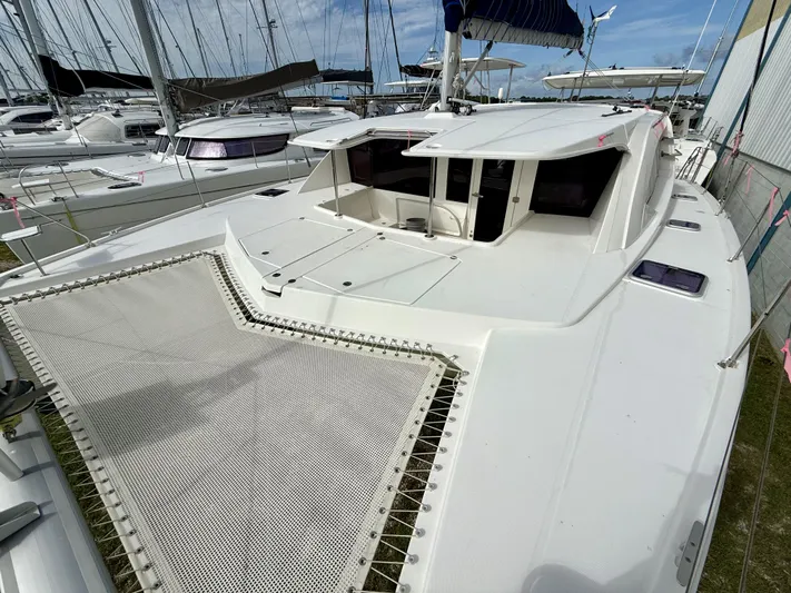 Diastema Yacht Photos Pics 2016 Leopard 44 catamaran with spacious deck and netting, docked in a marina.