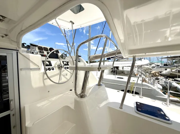 Diastema Yacht Photos Pics Helm station of a 2016 Leopard 44 catamaran with steering wheel and navigation controls.