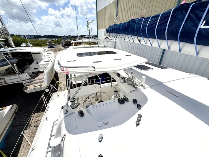 Diastema Yacht Photos Pics 2016 Leopard 44 catamaran docked, showcasing deck and sail cover under a sunny sky.