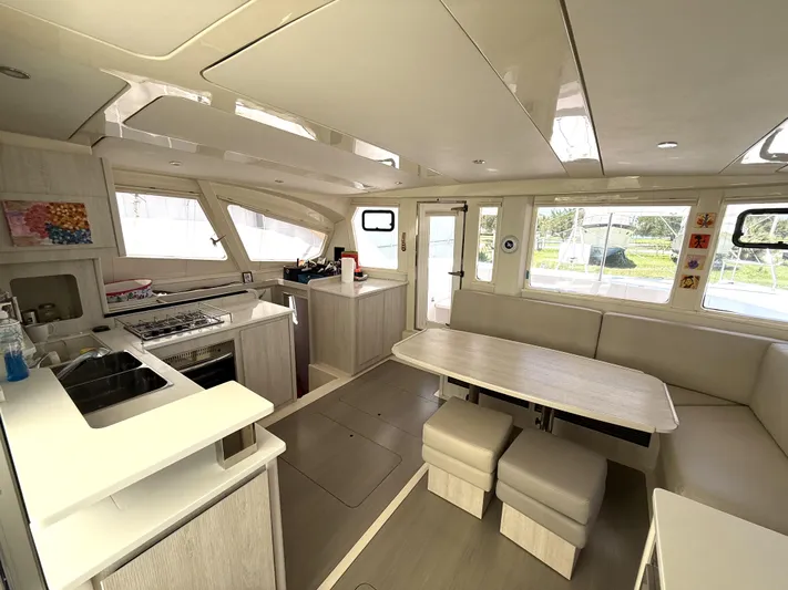 Diastema Yacht Photos Pics Luxurious interior of 2016 Leopard 44 catamaran with modern kitchen and spacious seating area.