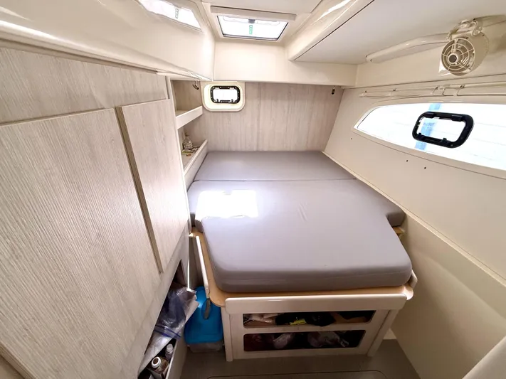 Diastema Yacht Photos Pics Cozy cabin interior of a 2016 Leopard 44 yacht with a comfortable bed and storage.