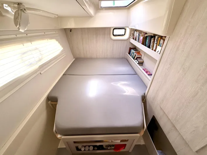 Diastema Yacht Photos Pics Compact cabin interior of 2016 Leopard 44 with bed, window, and bookshelf.