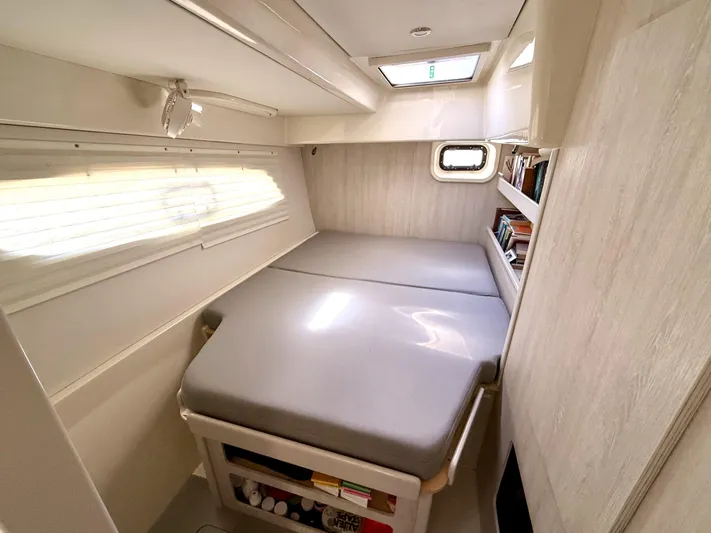 Diastema Yacht Photos Pics Cozy cabin interior of 2016 Leopard 44 yacht with bed and bookshelf.