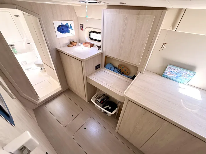 Diastema Yacht Photos Pics Interior of a 2016 Leopard 44 yacht featuring light wood cabinetry and a compact bathroom.