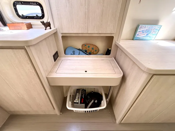 Diastema Yacht Photos Pics Interior of 2016 Leopard 44 yacht with storage compartments and decorative items.