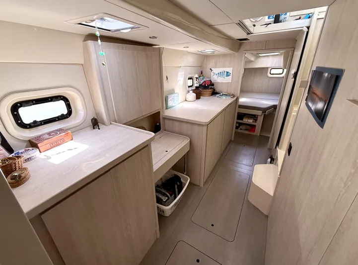 Diastema Yacht Photos Pics Interior of 2016 Leopard 44 yacht with modern wood finish and ample storage.