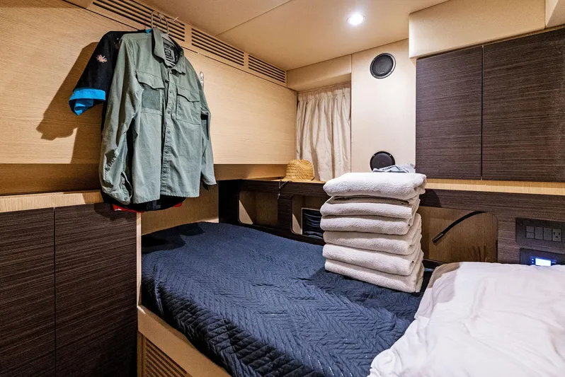 Fantastic Yacht Photos Pics Luxurious cabin interior of 2019 Azimut 77S yacht with bed and folded towels.