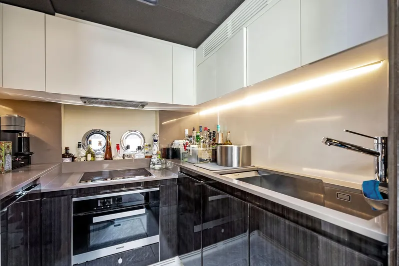 Fantastic Yacht Photos Pics Modern kitchen interior on 2019 Azimut 77S yacht with sleek cabinetry and appliances.