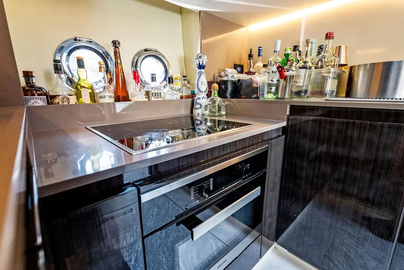 Fantastic Yacht Photos Pics Luxurious kitchen area on a 2019 Azimut 77S yacht with modern appliances and bar setup.
